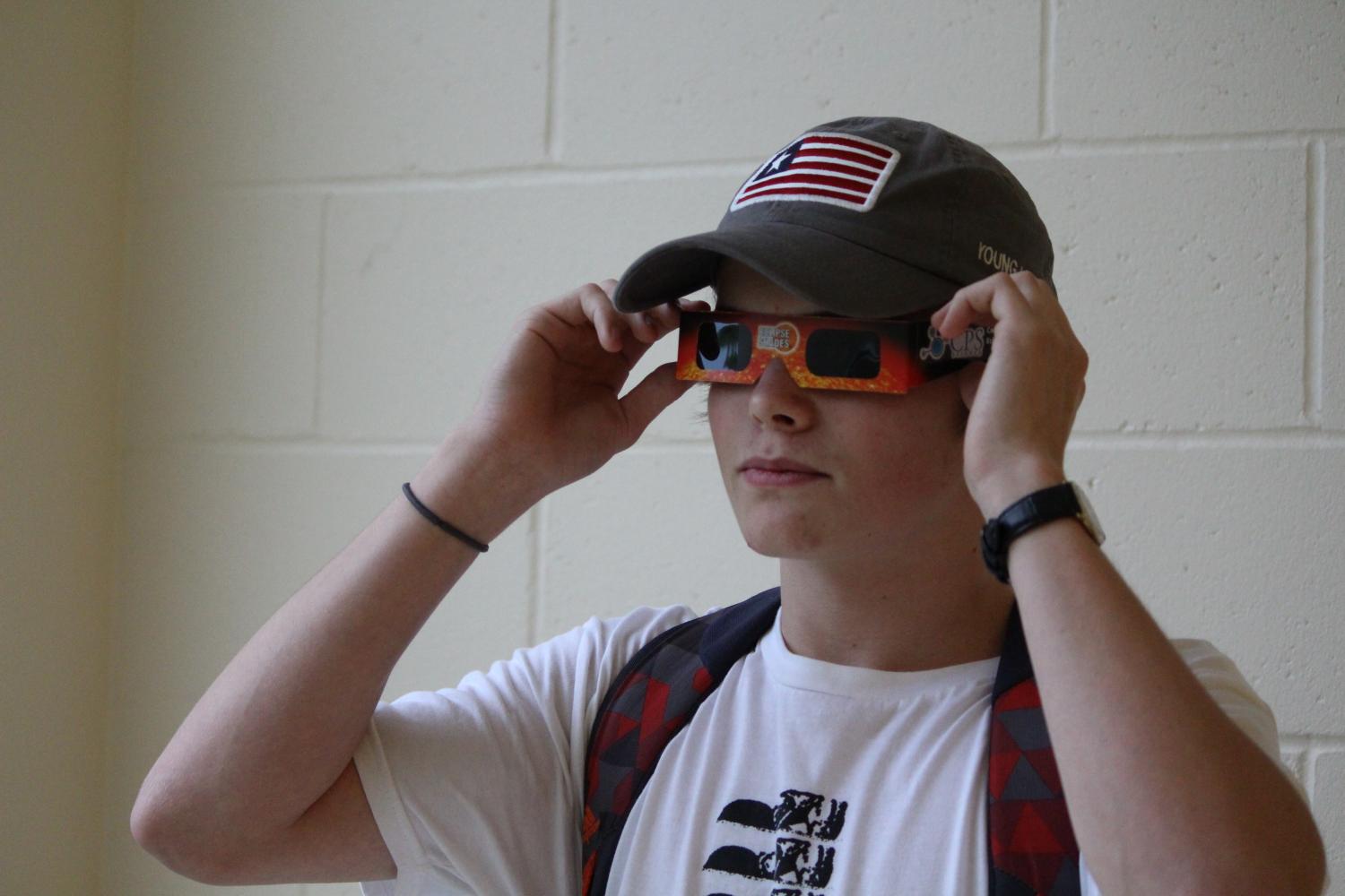 Zach Godbey tries on his solar eclipse glasses.