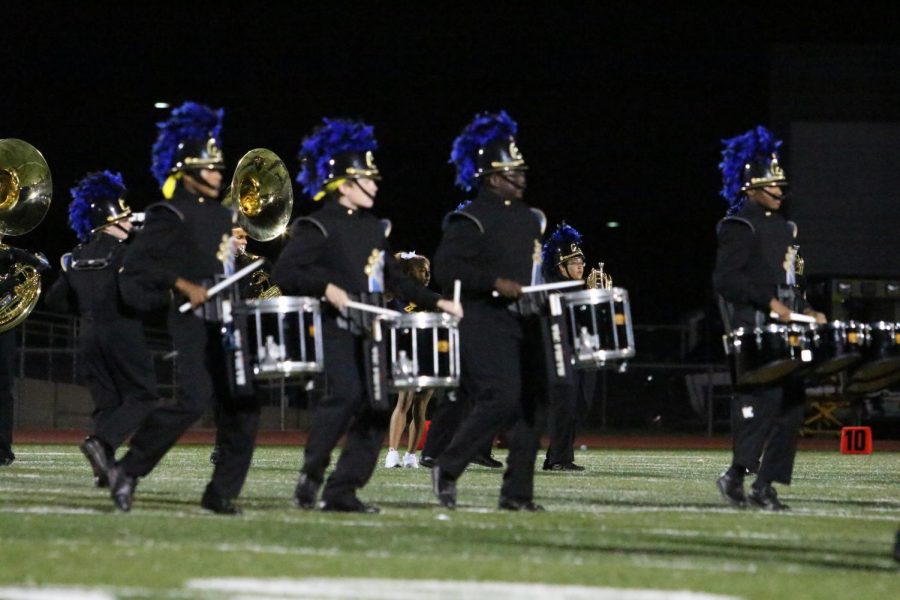 The marching band's 2018 fall show titled "Above and Beyond" showcases the curiosity human's have with space. The three movements describe the ascent into space from airplanes to outer space and beyond. The show features music from "Rocket Man" by Elton John and "The Planets" by Gustav Holst. 