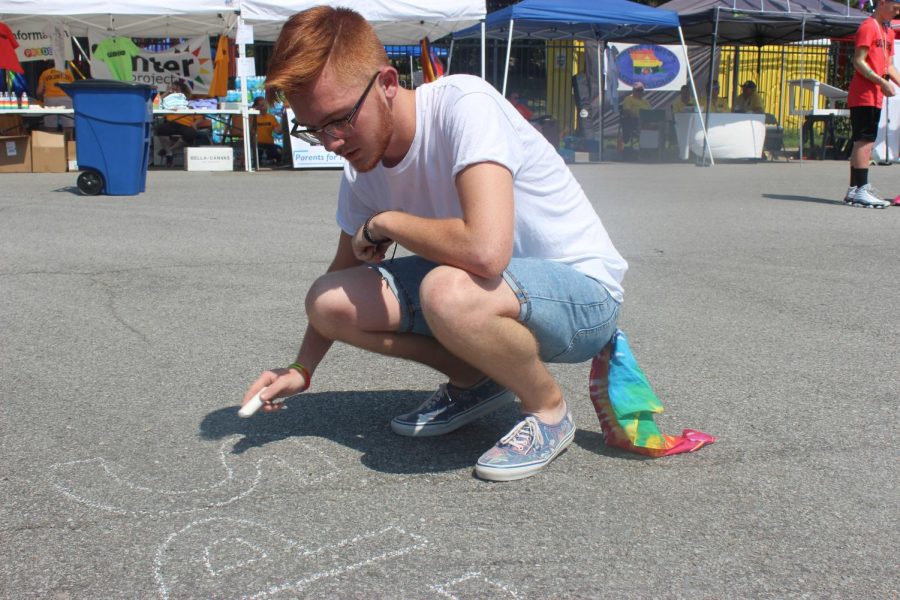 Ian Graves draws with sidewalk chalk