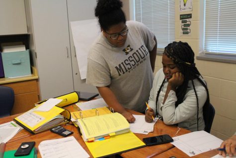 Amaya Daniels helps Anyha Cain with geometry honors in Mr. Collins.