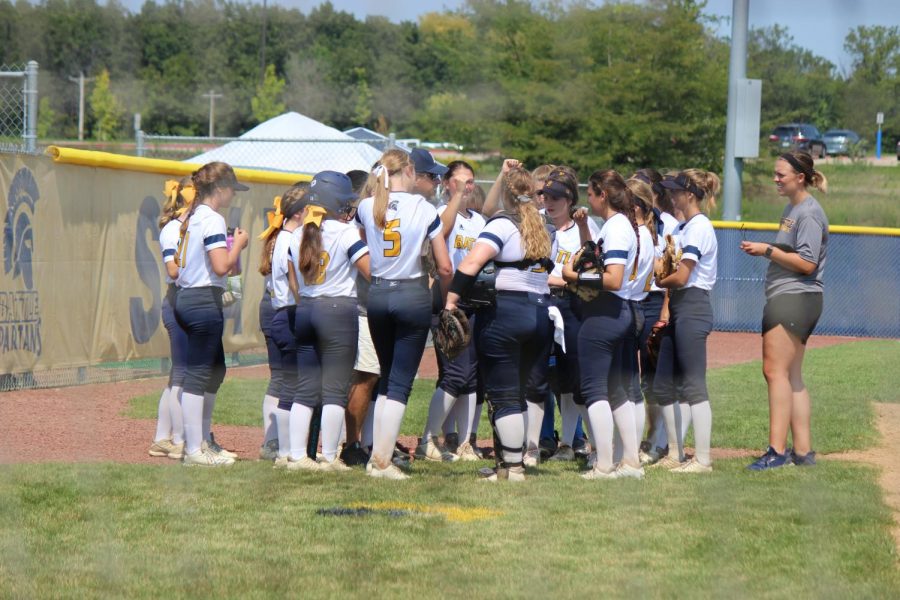 Team huddles around Coach Henderson in the last inning vs Blue Springs South.