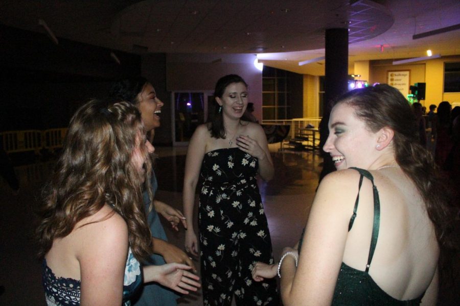 Taryn Criblez, Brihana Black, Kayli Lightner, and Emily Nowack laughing and enjoying the homecoming dance.