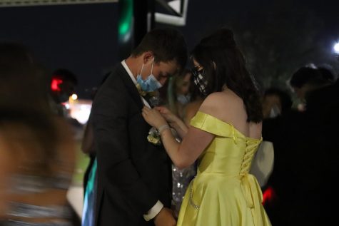 Prom attendee gets his corsage fixed by his date. Prom was attended by many, despite the pandemic. Photo by Aubrei Roland