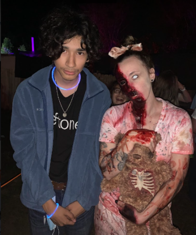 Junior Osmar Murillo takes a picture with one of the scare actors 