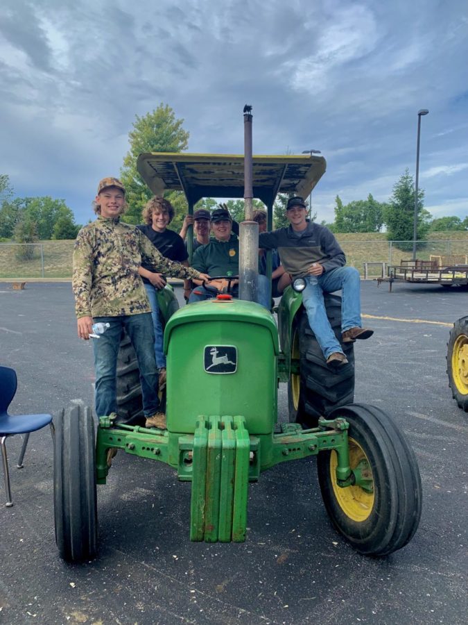 Students pose on their tractor.