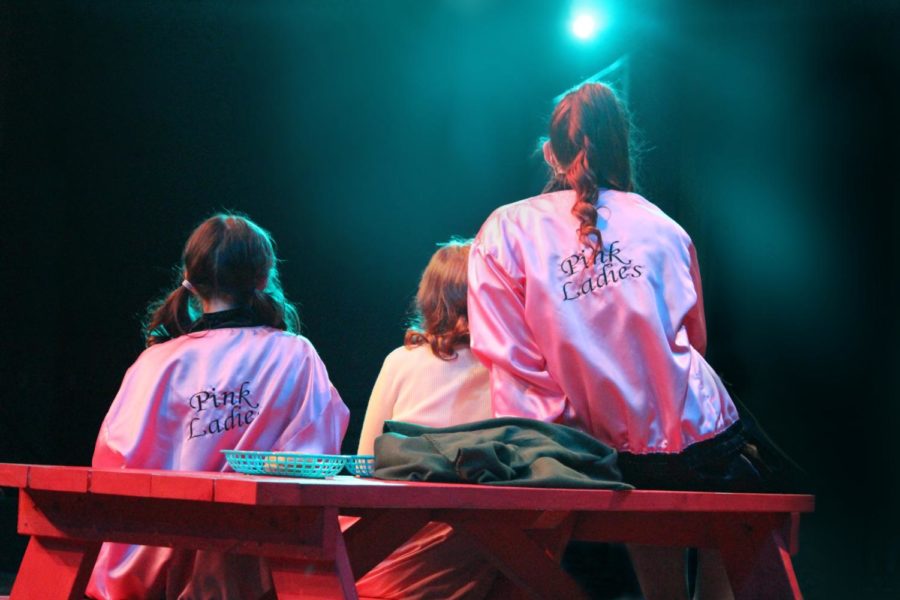 Pink+Ladies+sit+together+on+stage