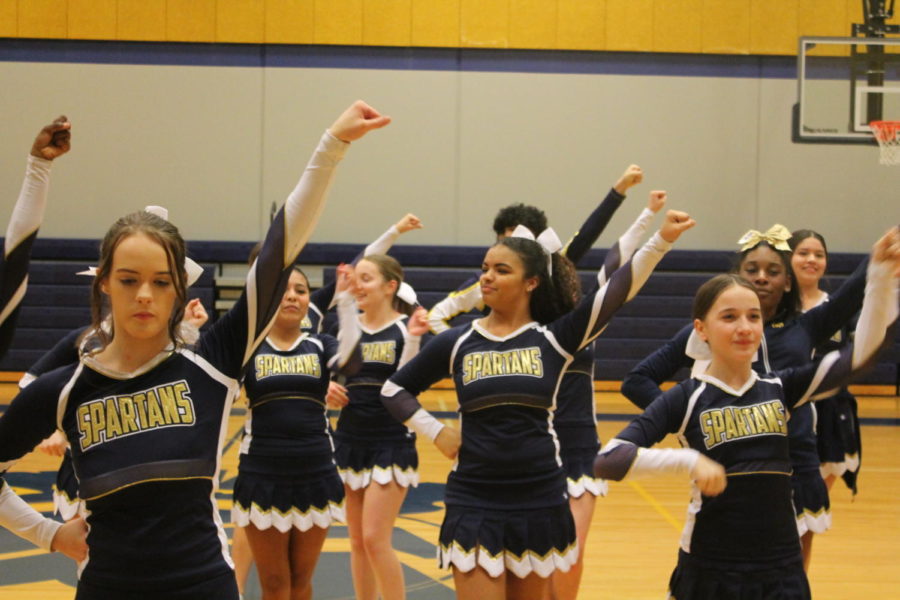 Battle cheer squad cheering at boys basketball game
