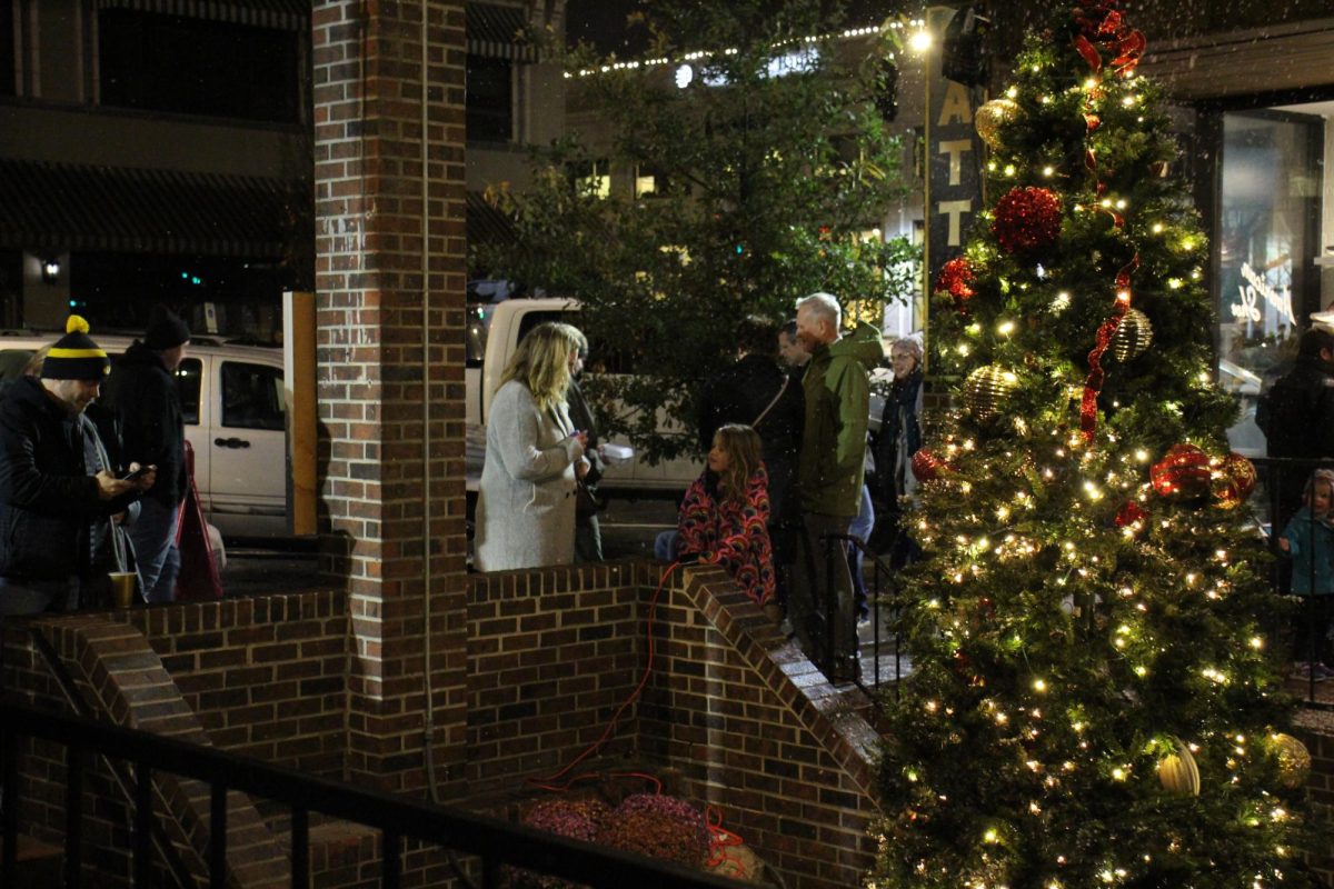 Families gathering around the Christmas tree by the Broadway Brewery 