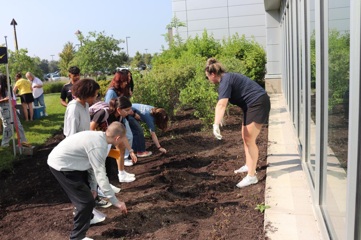 Ms. Wendell leads freshman in a planting activity planting bulbs for their class garden. Before the first day of school freshman participated in a Jump Start Day full of games, activities, and tours around the school.