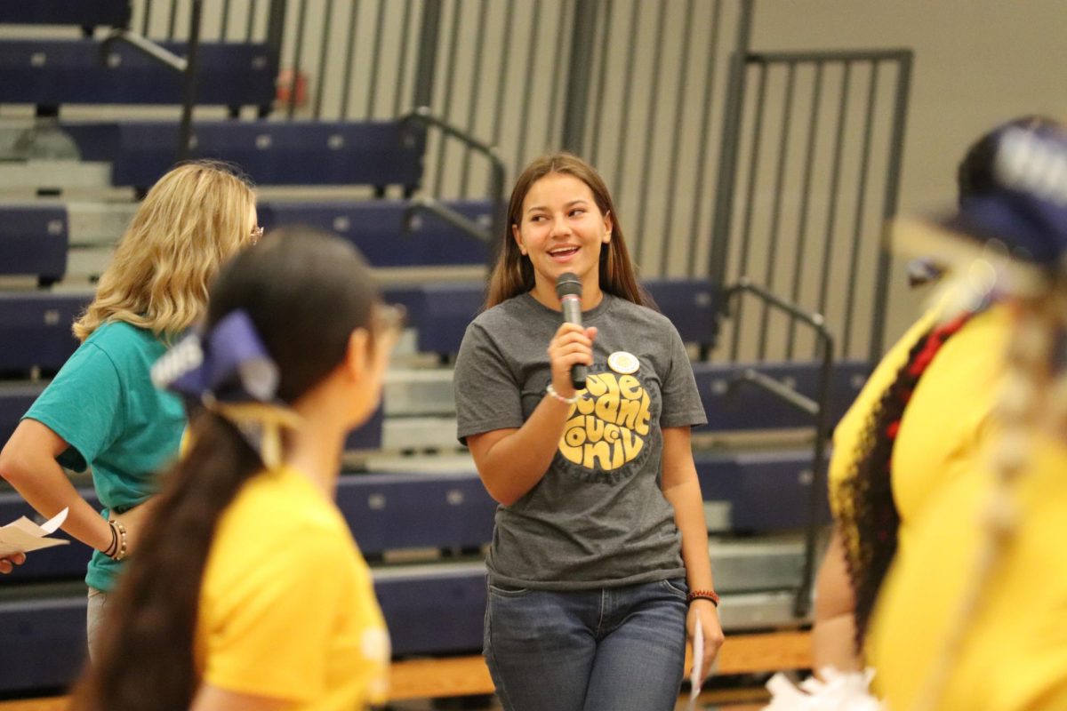 Senior Madison Pulliam speaks to freshman at jump start day. Before the first day of school freshman participated in a Jump Start Day full of games, activities, and tours around the school.