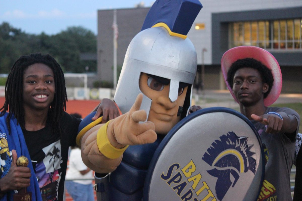 Antoine "AJ" Edwards and Kaelyn "KJ" Johnson pose with Battle's Spartan mascot at Battle-Hickman game on September 19, 2025. 