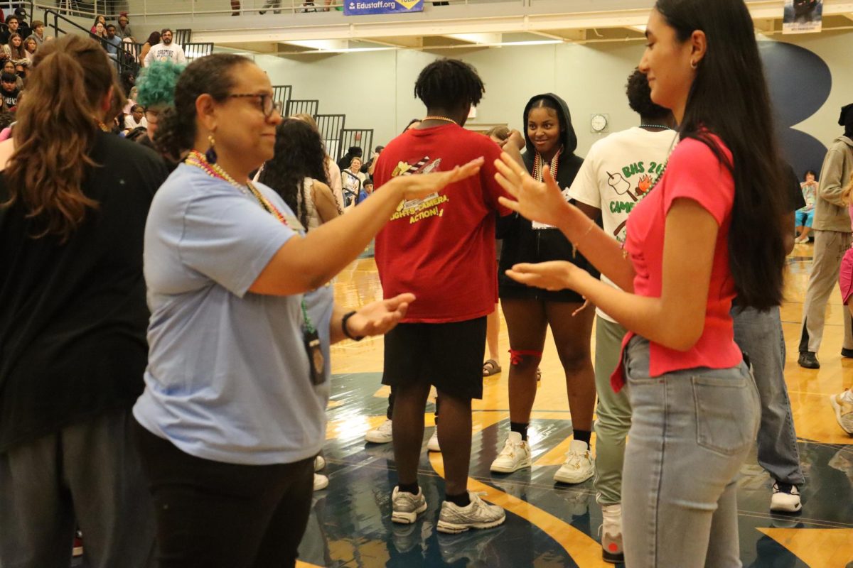 EL teacher Ms. Amy Jammeh and Sophomore Mariana Flores Hernandez playing rock paper scissors to see who wins the beads on Friday for Bead Day.
